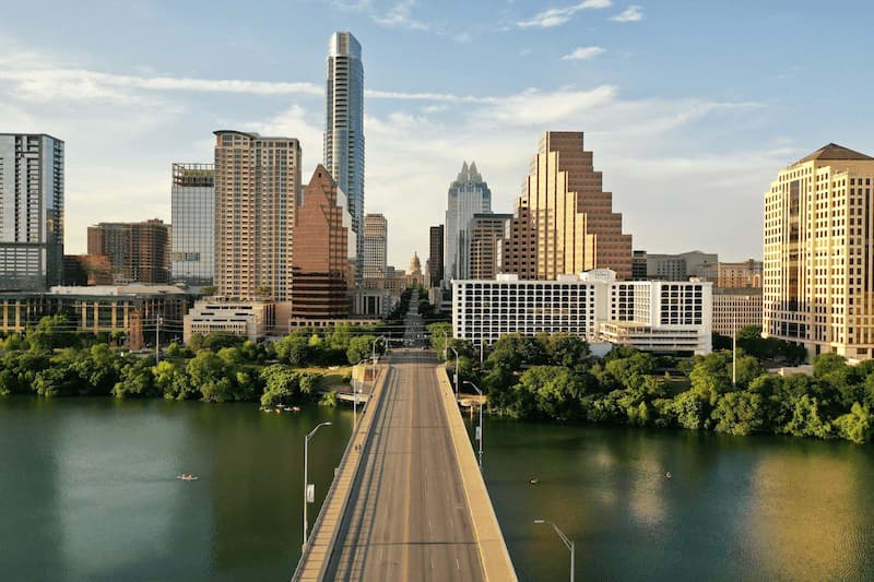 Austin skyline with Lady Bird Lake in the foreground, showcasing the city's blend of urban development and natural beauty