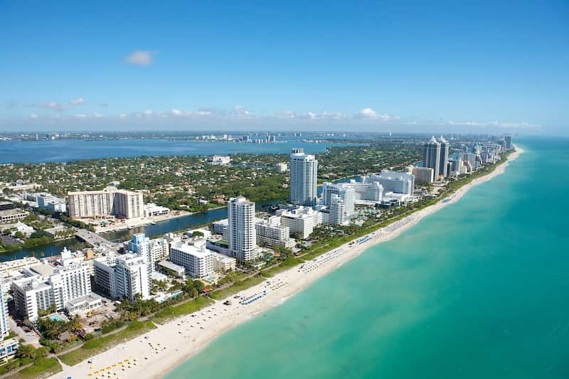 Miami skyline at sunset with palm trees and Biscayne Bay